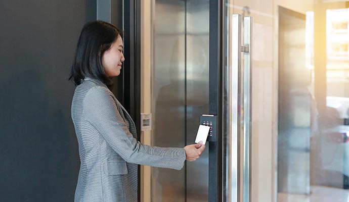 A person is using business access control keycard A person is using business access control keycard