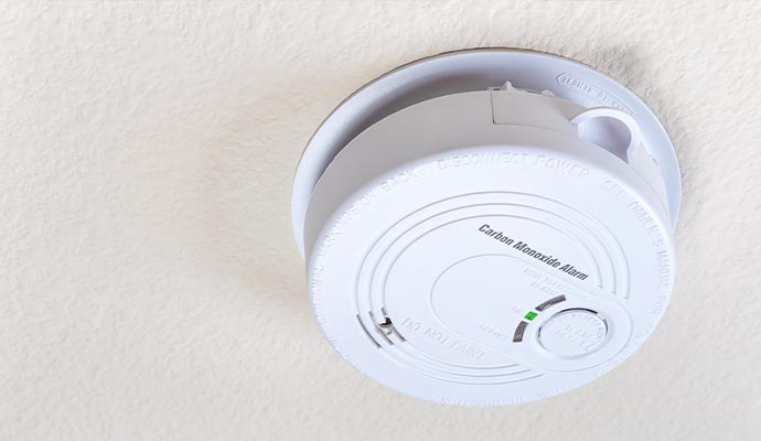 Wall-mounted carbon monoxide detector ensuring air safety in a party hall