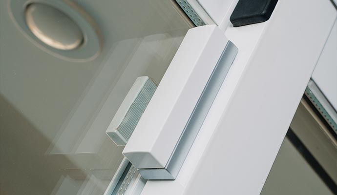 Glass break detector installed on a wall to detect shattered windows