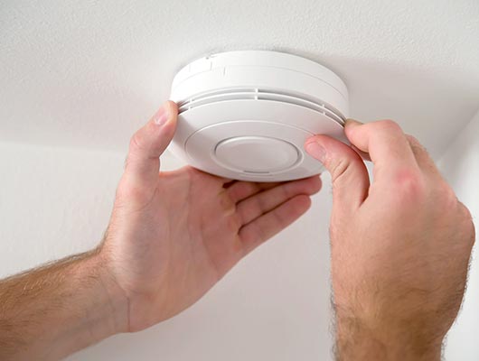 man covering his mouth with hand to prevent inhaling carbon monoxide