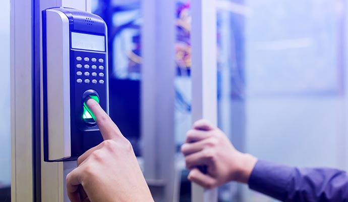 A person using a fingerprint access control system
