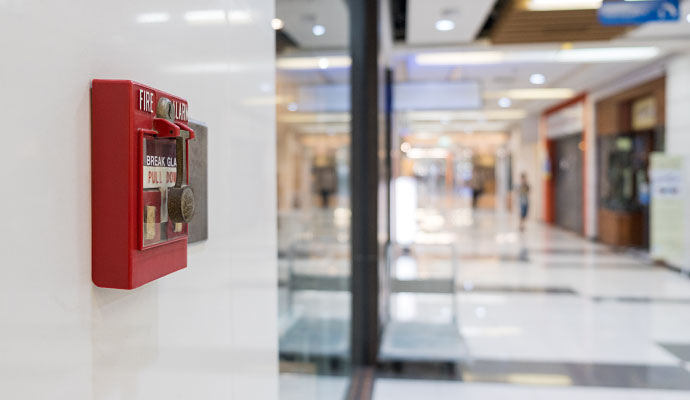 Fire alarm pull station in retail hallway