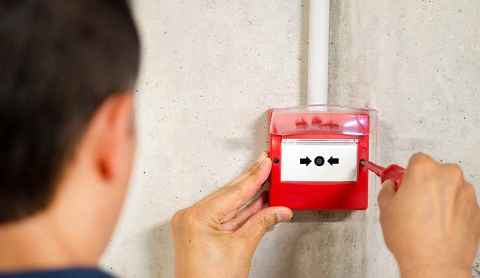 Expert installing fire alarm