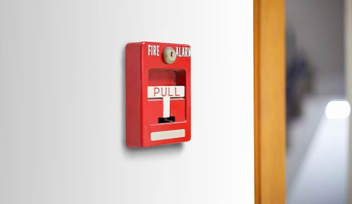 Fire alarm pull station on wall