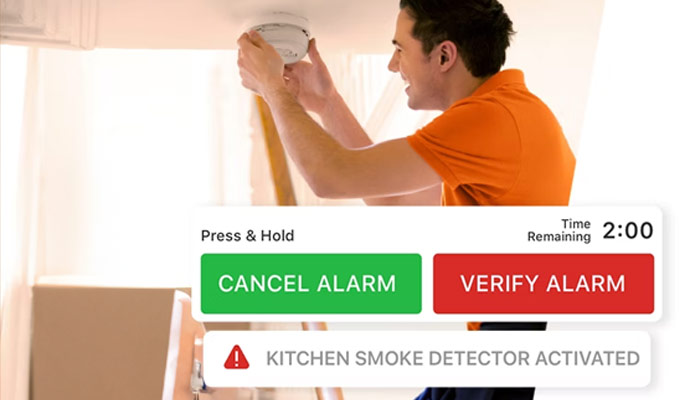 Person checking smoke detector with alarm notification overlay.