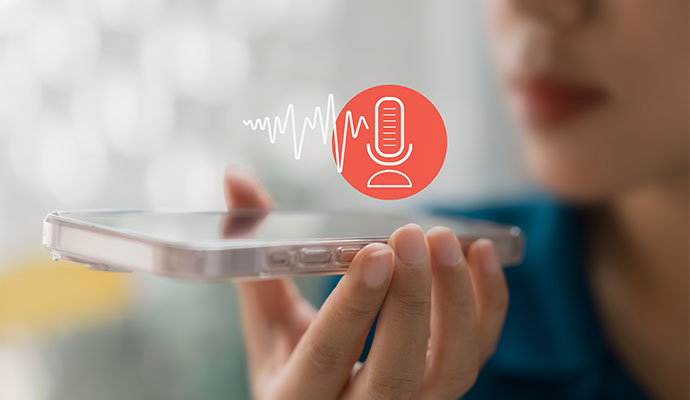 A person using a smartphone to giving command for the voice control system