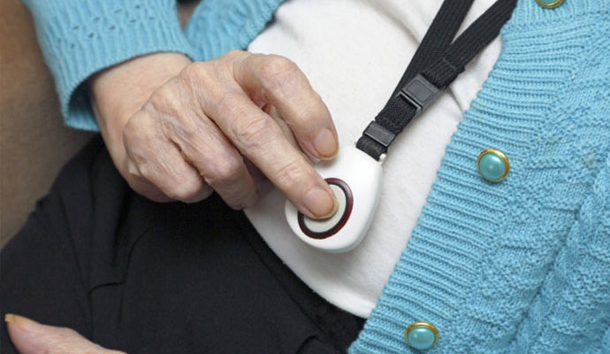 an elderly person using a medical alert system