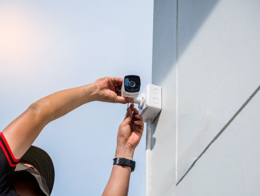 technician installing outdoor security camera