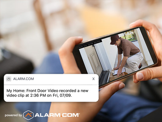 Smartphone showing Alarm.com notification of front door video clip