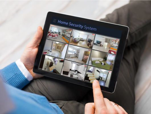 Tablet displaying multiple home security camera feeds.