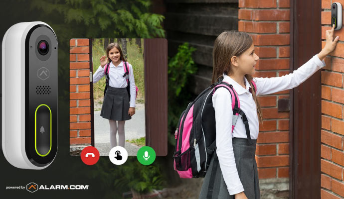a small girl standing in front of a video doorbell camera
