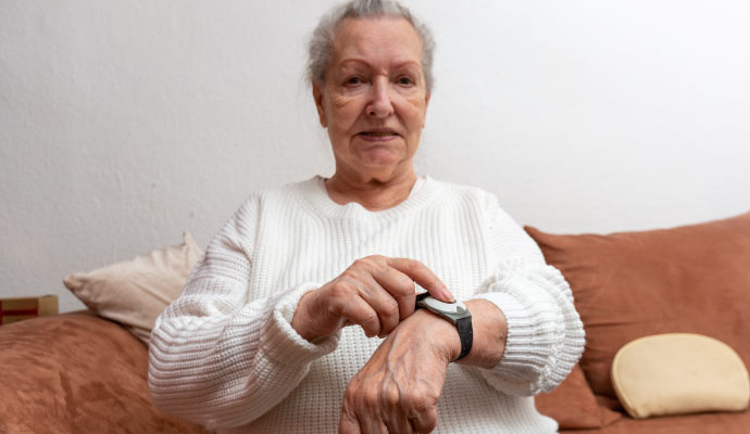 an elderly person using a medical alert system