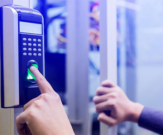A person using a fingerprint access control system A person using a fingerprint access control system