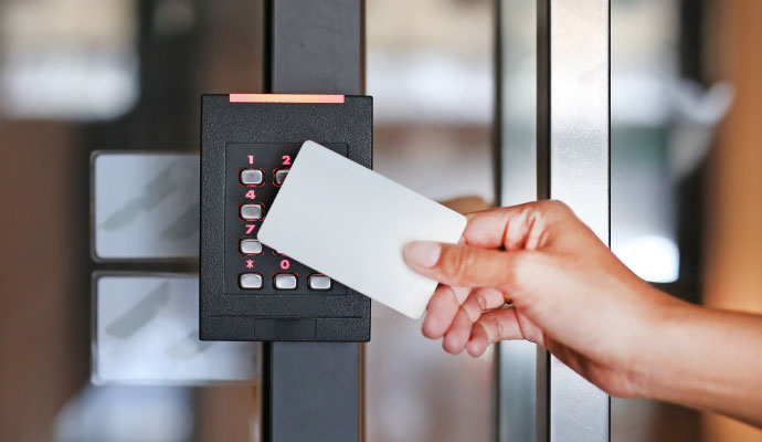Person using a key card reader for access