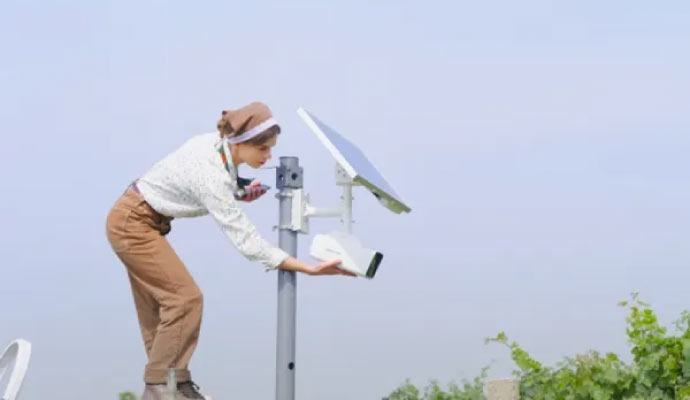 Person installing solar powered camera