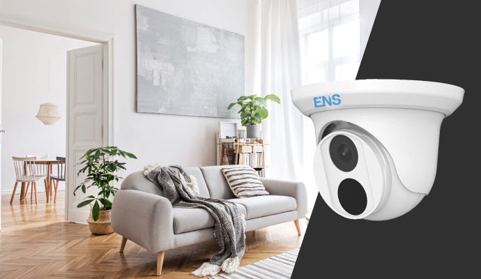 A modern living room and a dome security camera