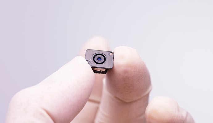 A person holding a hidden security camera in his hand A person holding a hidden security camera in his hand