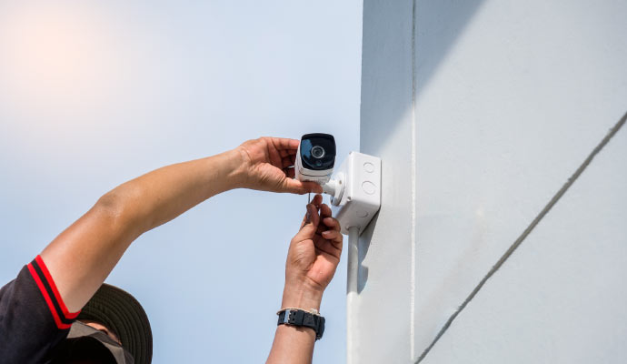 Person installing home security camera