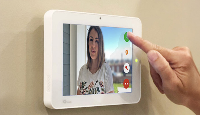 Person using a wall mounted 2-way communication system