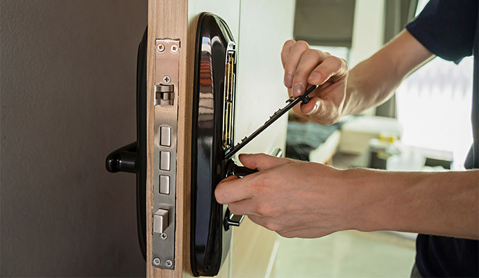 Technician installing and configuring a smart electronic door lock