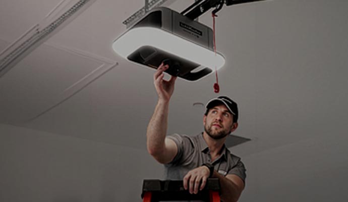 Technician adjusting LiftMaster smart garage door opener