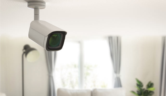 Wireless indoor security camera mounted on ceiling in modern living room