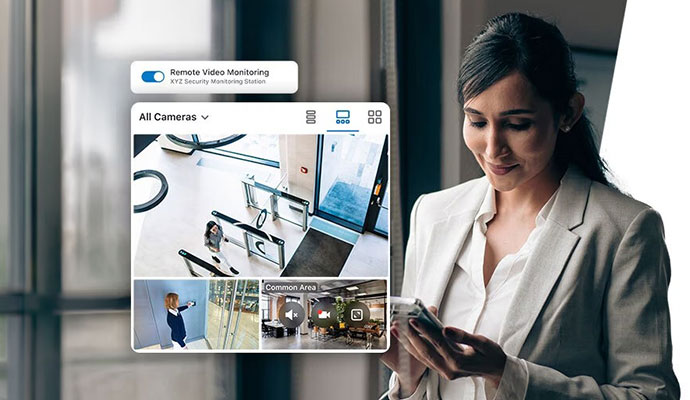 Woman monitoring live video feed of office space using a smartphone