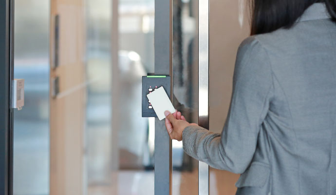 Woman using a key card for office access